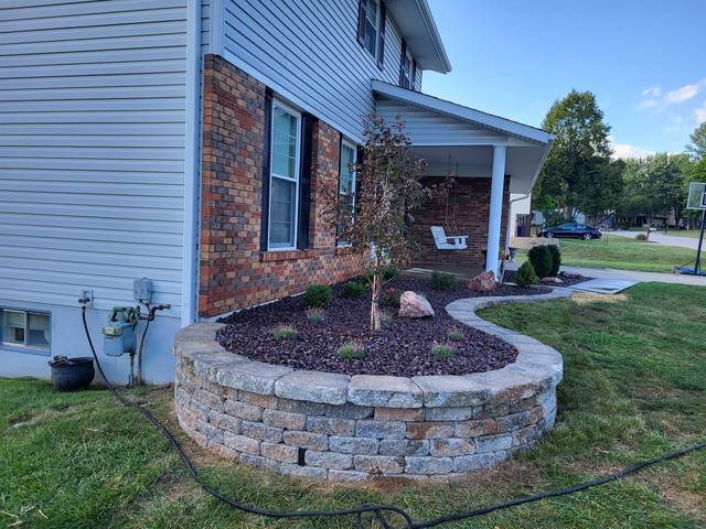 Raised bed wall wrapping the corner of a porch