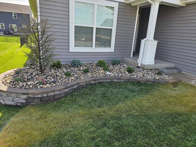 Rock bed and wall across the front of the house