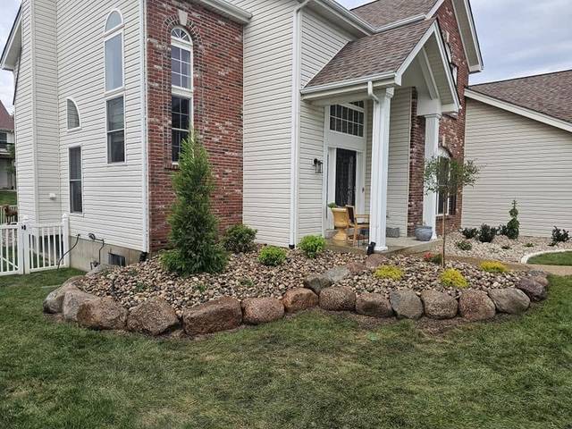 Boulder-edged bed with a young evergreen